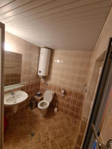 a bathroom with a toilet and a sink at Sunny House Byala in Byala +86 photos