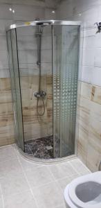 a shower stall in a bathroom with a sink at ضيف المشاعر in Makkah