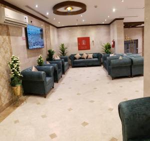 a waiting room with blue couches in a lobby at ضيف المشاعر in Makkah