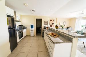 a kitchen with white counters and a large counter top at Apartment Almas Iberosta Bavaro 3BDR with Pool and Private Beach in Punta Cana
