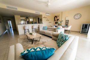 a living room with a couch and a table at Apartment Almas Iberosta Bavaro 3BDR with Pool and Private Beach in Punta Cana
