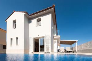 a white villa with a swimming pool at Molly's Villa in Protaras