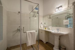 a bathroom with a glass shower and a sink at amã Stays & Trails - Wayside Villa, Kurseong in Karsiyang +34 photos