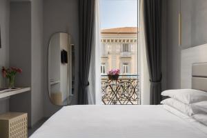 a bedroom with a bed and a large window at The Grey in Naples