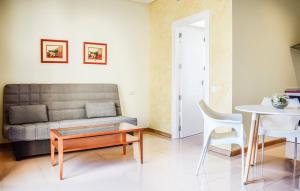 a living room with a couch and a table at Hotel Playa Sol by ALEGRIA in Puerto de Mazarrón