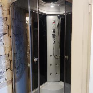 a shower with a glass door in a bathroom at Ventspils apartamenti pie Rātslaukuma in Ventspils