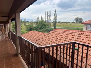 a balcony with a view of a roof at Just Bed & bath by mama R in Newcastle