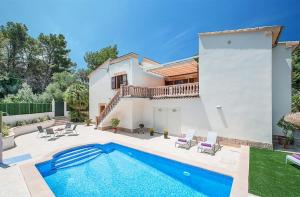 a villa with a swimming pool and a house at Tacaritx de Bonaire, with pool and garden in Alcudia