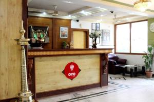 a lobby with a bar with a sign on it at OYO Hotel Ganga Sagar Near Sri Someshwara Swami Temple in Bangalore