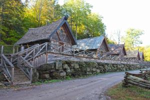 a building with a stone wall next to a road at Vikings Villages Resort in Guilford