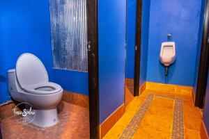 a bathroom with a toilet and a urinal at Time Sabai 32 in Bangkok