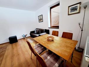 a living room with a wooden table and chairs at Apartmán Severanka in Vysoké Tatry