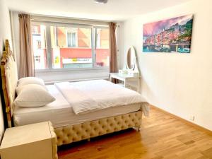 a bedroom with a bed and a large window at City Apartment - close to town - by PA in Luzern