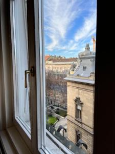 a view of a building from a window at Zen Hostel by Central Market in Budapest