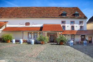 a large white building with a red roof at Gästehaus Schloss Janson in Kleinbockenheim
