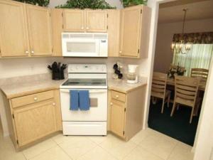 a kitchen with a white stove and a microwave at Turkey Oak Villa IR021 in Kissimmee