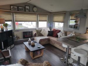 a living room with a couch and a table at "Dew Drop Inn" in Port Seton