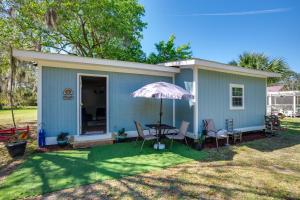 a small blue house with a table and chairs at Saint Helena Island Getaway with Marsh Views! in St. Helena Island