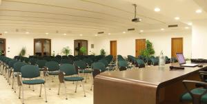 a room with a rows of chairs and a table with a laptop at Locanda Del Parco Hotel in Colledara