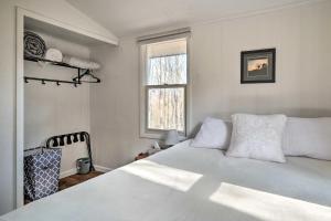 1 dormitorio con cama blanca y ventana en Unplugged Mountain Retreat with Porch Swings! 