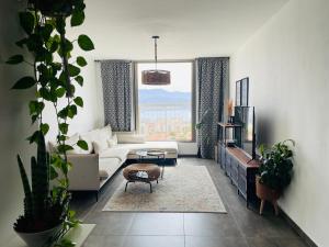 a living room with a white couch and a window at view point relax in Eilat