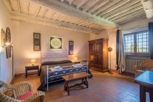 Sala de estar con cama y mesa en Casale Rosennano - Riserva en Rosennano