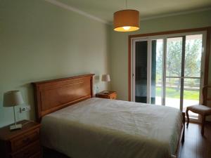 a bedroom with a bed and a sliding glass door at Casa da Viña in Guillade +51 photos