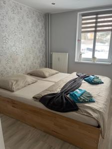 a bedroom with two beds and a window at Ubytovanie pod štítmi Vysokých Tatier in Tatranska Strba