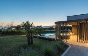 a house with a palm tree in the middle of a yard at Villa Dual in Sveti Petar u Šumi