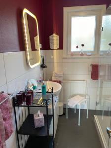 a bathroom with a sink and a mirror at Ferienwohnung Panoramablick Freudenstadt in Freudenstadt +31 photos