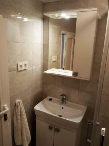 a bathroom with a sink and a mirror at Novalja Apartments in Stara Novalja