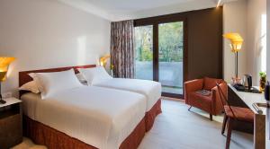 a hotel room with a bed and a window at Axel Hotel San Sebastián - Adults Only in Donostia-San Sebastián