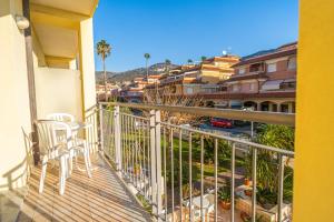a balcony with chairs and a view of a city at Residence Villa Gloria in Borgio Verezzi