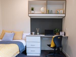 a bedroom with a bed and a desk with a laptop at For Students Only Ensuite Bedrooms with Shared Kitchen at Powis Place minutes away from Aberdeen City Centre in Aberdeen