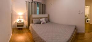ein Schlafzimmer mit einem Bett in einem Zimmer mit einer Lampe in der Unterkunft Pátio das Cantigas in Góis