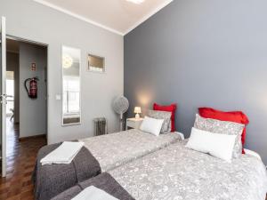sypialnia z dużym łóżkiem i czerwonymi poduszkami w obiekcie Akisol Faro Sunny w Faro