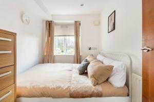 a white bedroom with a bed with pillows on it at Stunning Flat by Quayside with Balcony!! in Newcastle upon Tyne