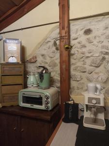 a kitchen with a toaster and a microwave on a table at La Rupe Bed and Breakfast in Norma