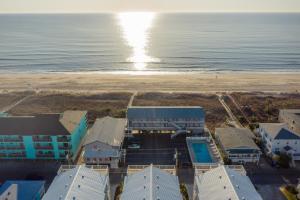an aerial view of the beach and buildings at The Beach House in Carolina Beach