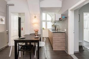 a kitchen and dining room with a table and chairs at Apartment Napoleon in Ljubljana