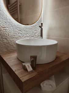 a bathroom with a white tub and a mirror at Camera sul Mare in Messina