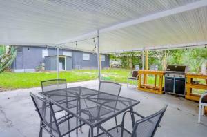 a patio with a table and chairs under a tent at 4br 3ba Spacious Home 2 Master Suites Near Usf in Tampa