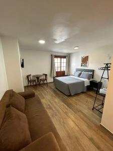 a living room with a bed and a couch at Bahia Pelô Hostel in Salvador
