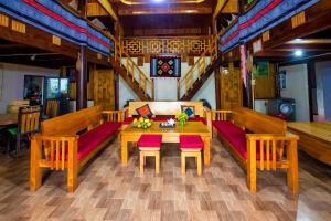 a dining room with a wooden table and benches at Hoa's homestay Sapa in Sa Pa