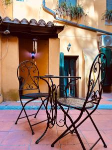 a table and chairs sitting next to a building at Piazza Verdi Apartment in Bologna
