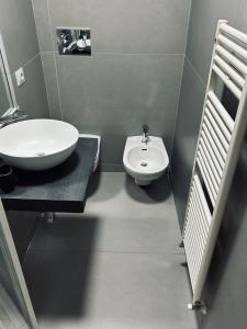 a bathroom with a white sink and a toilet at Piazza Verdi Apartment in Bologna