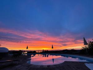 The sunrise or sunset as seen from the country house or nearby