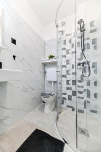 a bathroom with a toilet and a glass shower at Apartment Lusy Lo in Zadar