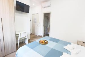 a bedroom with a table with a plate of food on it at B&B MARE E POESIA Salerno in Salerno