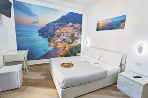 a bedroom with a bed with a view of the city at B&B MARE E POESIA Salerno in Salerno